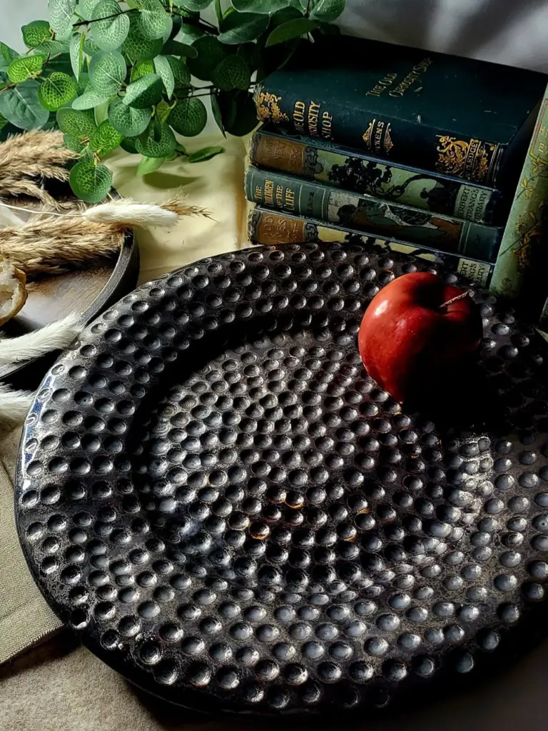 large dimpled pottery platter in bronze